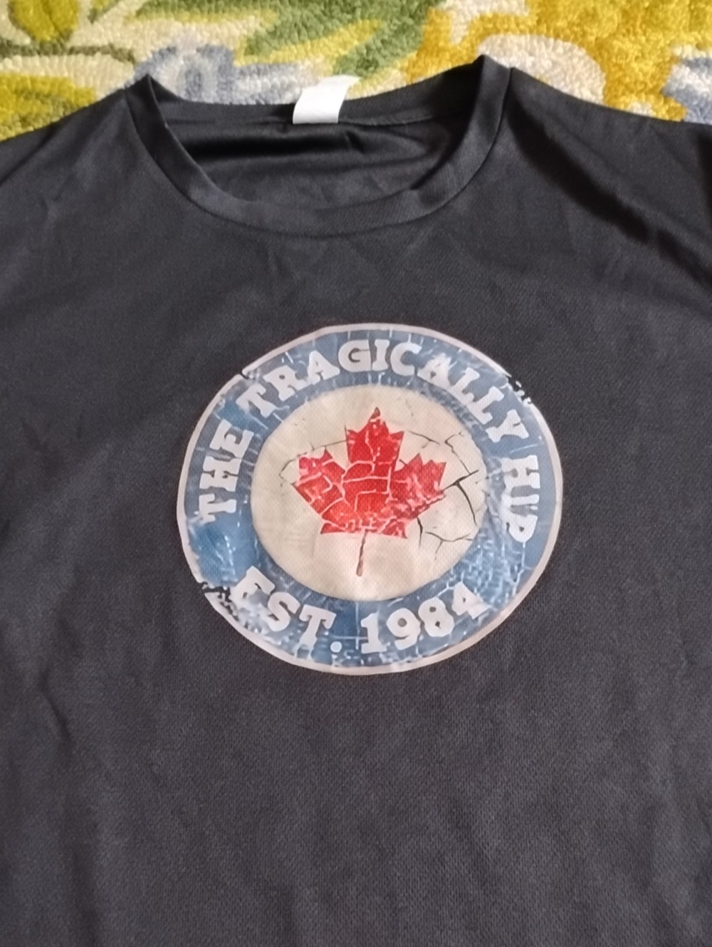 Source Unknown Black Tee with Red Maple Graphic and Blue Ring